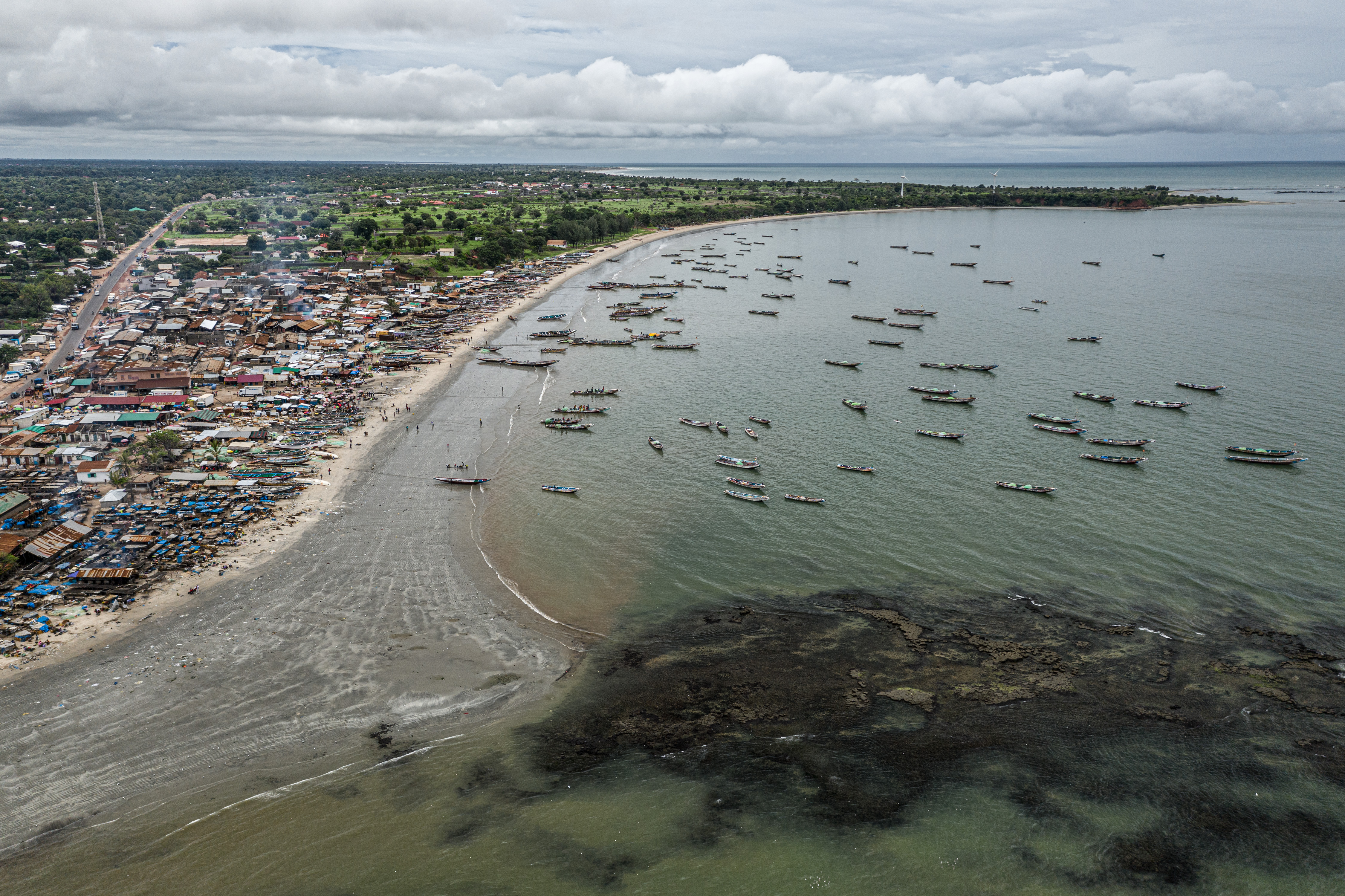 Fishing boats crowded Gunjur’s bustling coastline in The Gambia in 2019, returning daily to land their catch. Fishmeal production in the area fueled environmental pollution, food shortages, and rising tensions with local communities over access to fish and the disposal of factory waste.