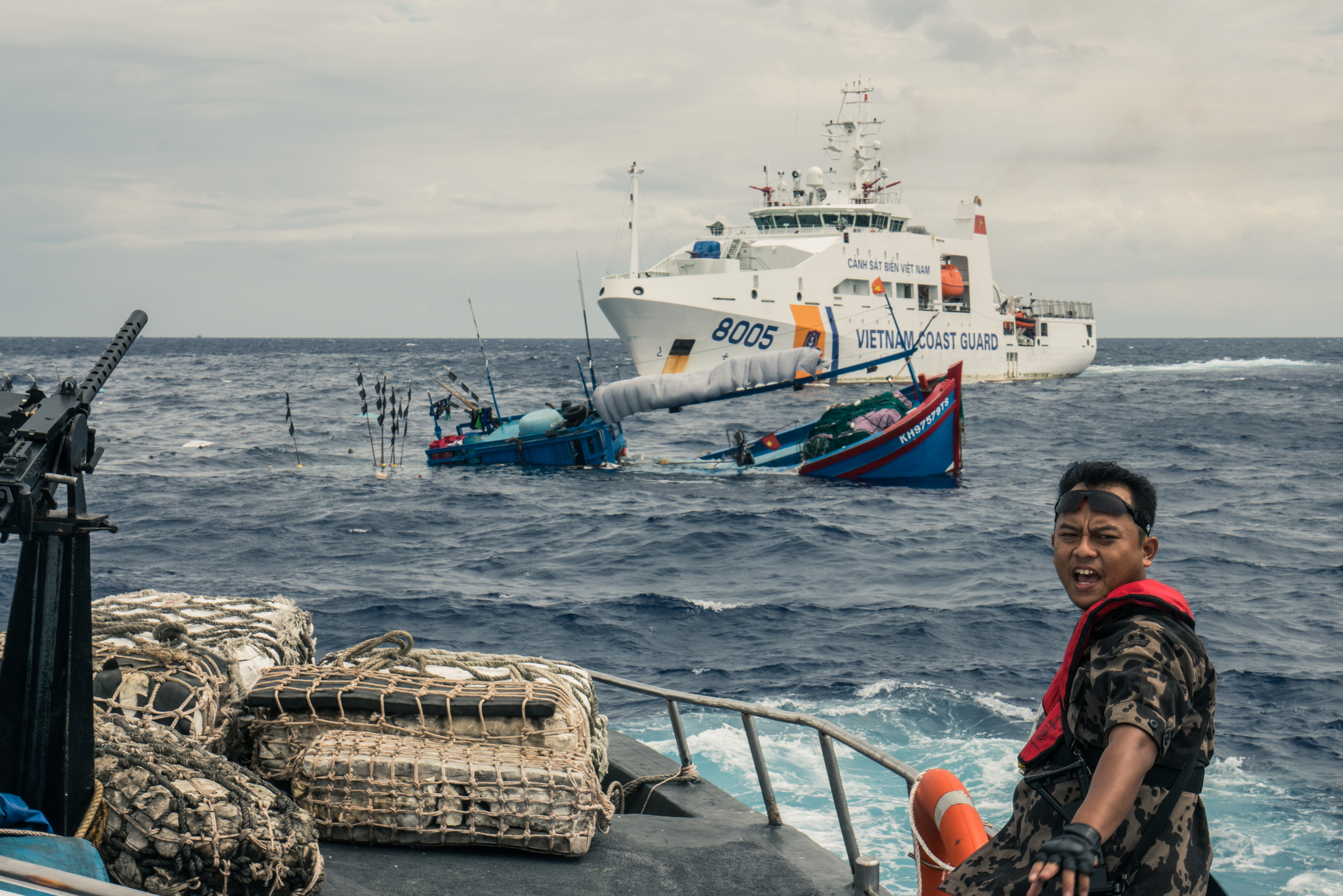 Vietnamese deckhands cling to a sinking fishing ship after a violent clash in 2017 between Indonesian and Vietnamese fishing authorities. Overfishing has intensified tension between the two countries.